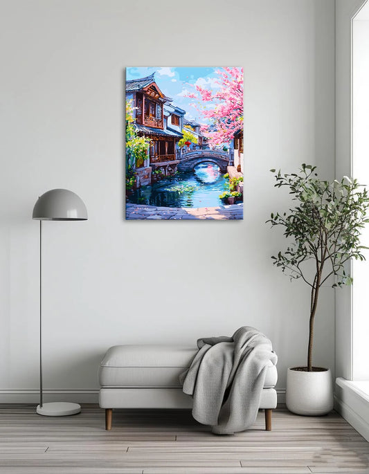 A serene painting of a village with a river flowing under a charming bridge.